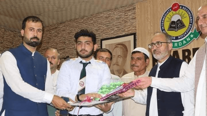 Moeen Ahmad being honored for placing second in district ICS