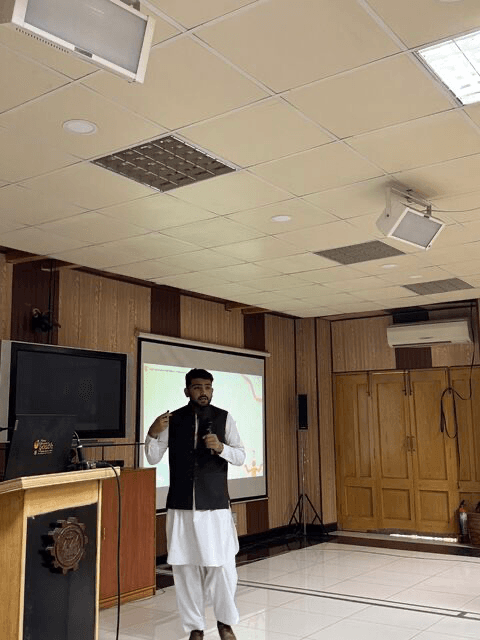 Moeen Ahmad speaking about technology and development at a seminar